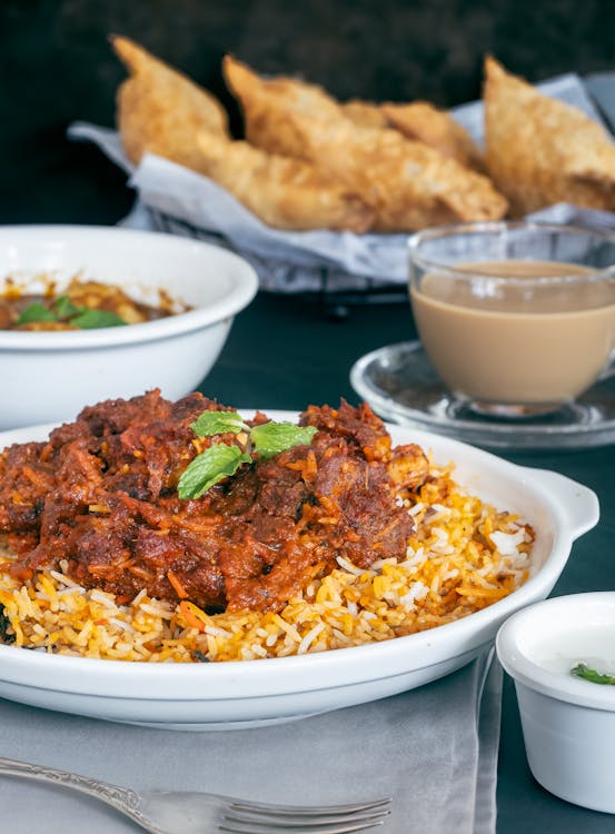 A beautifully laid out table with a traditional Eid biryani dish