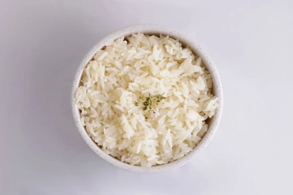 A close up of fluffy perfectly cooked rice in a pot - rice cooking mistakes