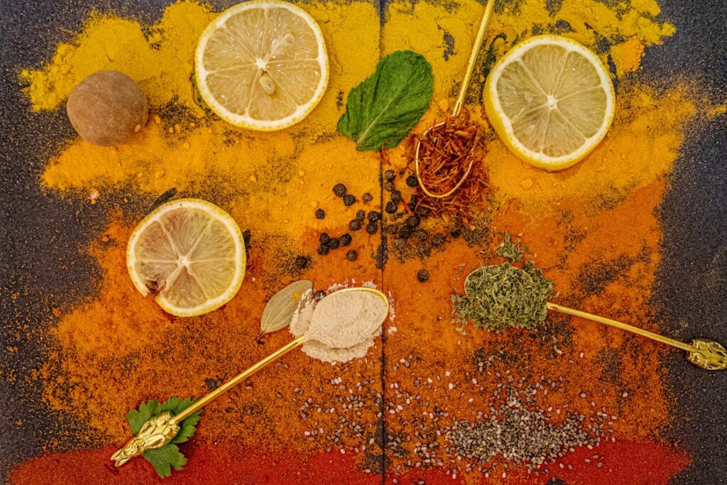 A colorful vibrant shot of common immune boosting spices like turmeric ginger garlic and black pepper