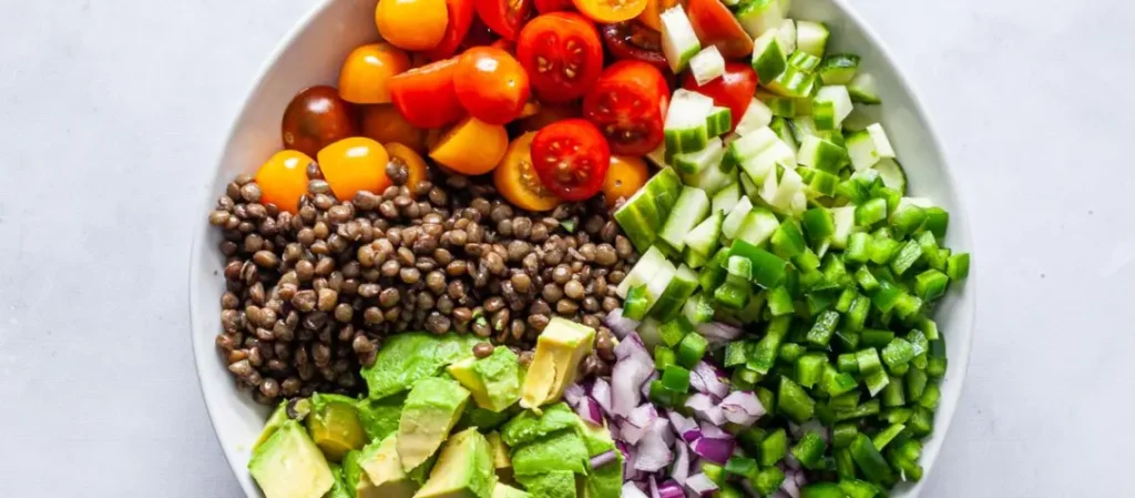 A healthy lentil salad with avocado cherry tomatoes and greens for a modern fresh take on lentils