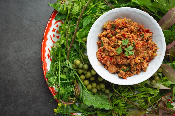 A close shot of the plated keema with visible spices garnished with fresh herbs