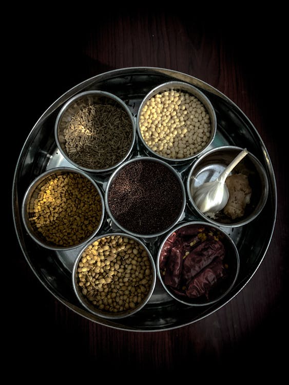 A vibrant image of a traditional spice market, showcasing a variety of whole Pakistan Masala spices.