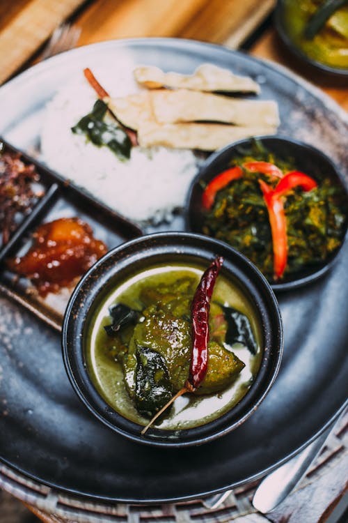 Showcase the beautifully plated Nihari garnished with fresh coriander green chilies ginger julienne and lemons