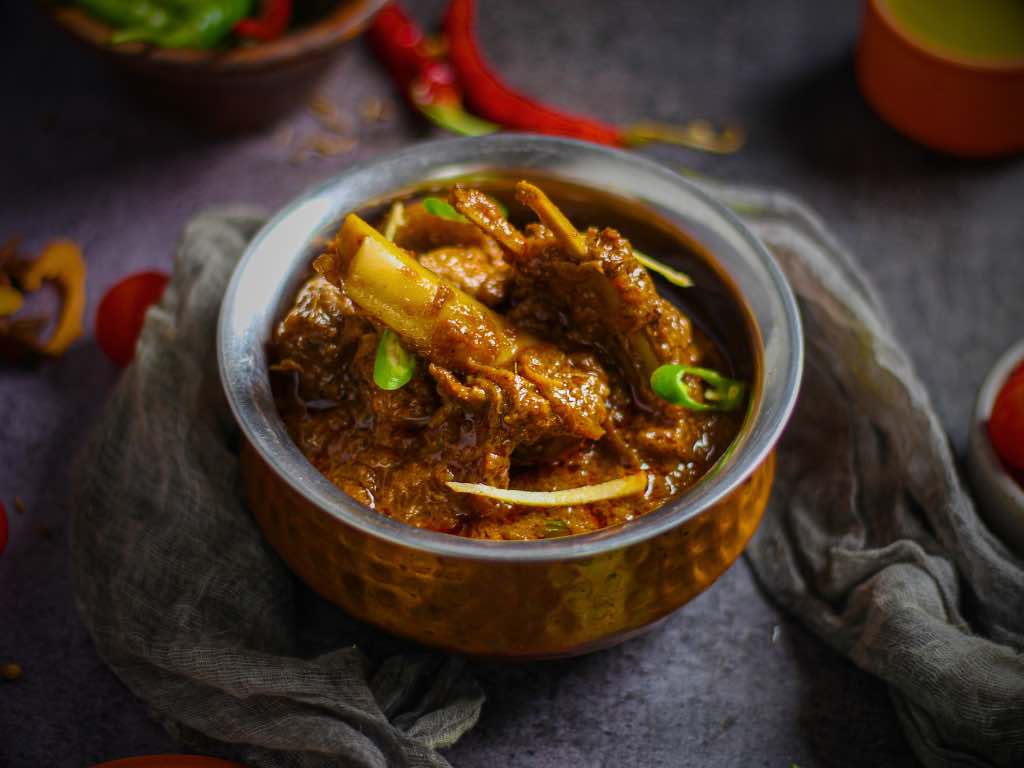 Step by step images of preparing the Paya dish highlighting the slow cooking process